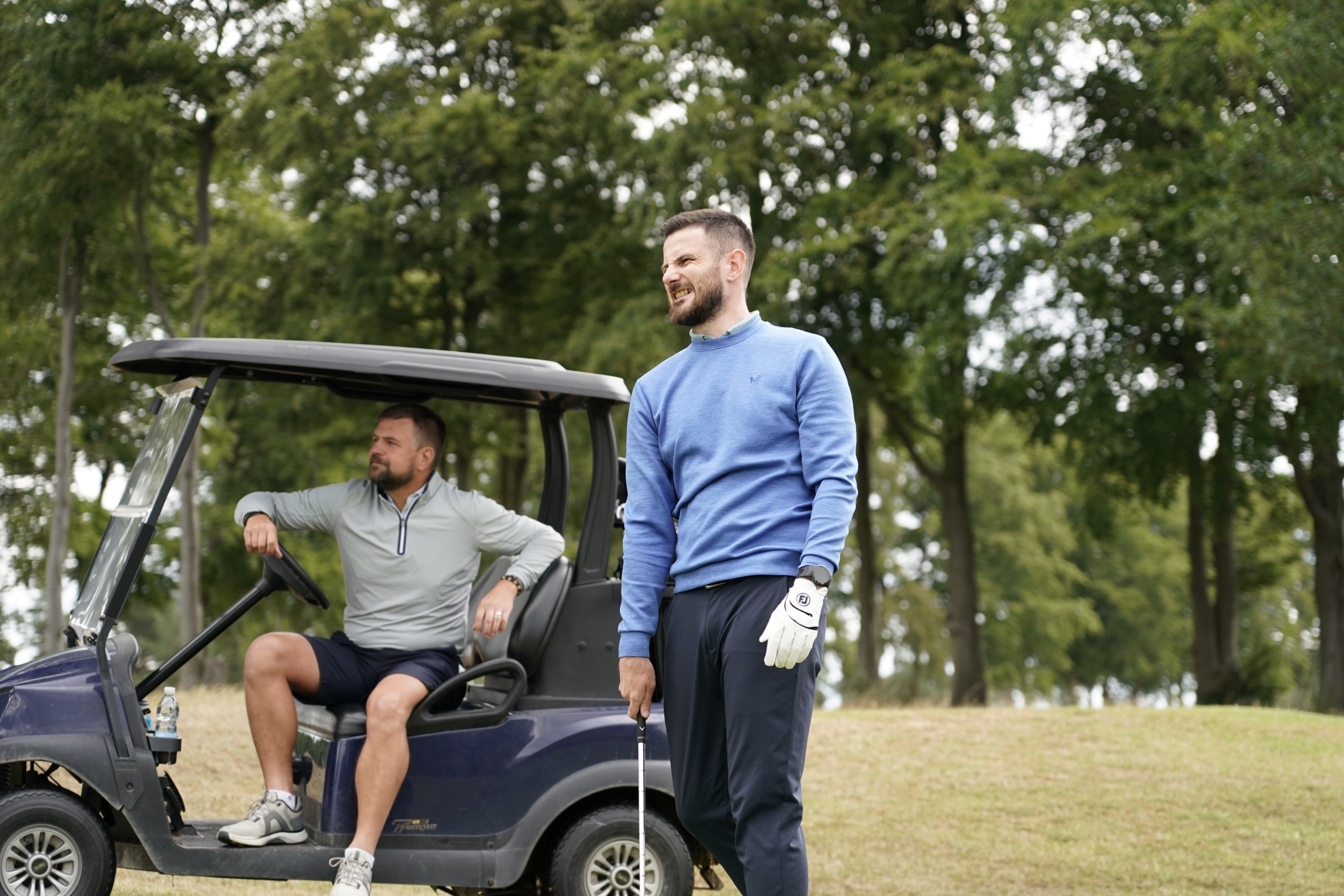 Baz Plummer grimacing after chunking his chip shot into the bunker