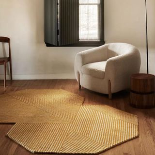 A yellow and white illusion rug features an abstract shape and pattern