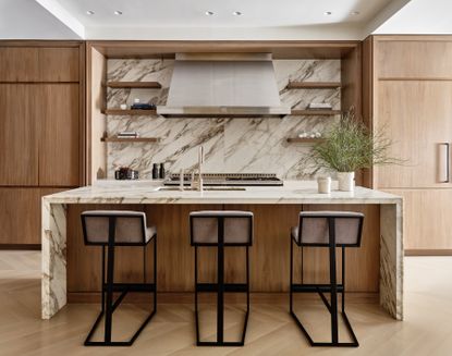 A kitchen with tall stools as island seating