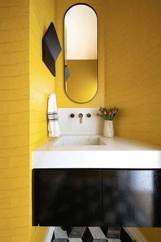 bathroom with yellow walls and white countertop