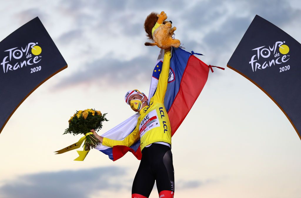 PARIS FRANCE SEPTEMBER 20 Podium Tadej Pogacar of Slovenia and UAE Team Emirates Yellow Leader Jersey Celebration Mascot Flowers Mask Covid safety measures Slovenian Flag during the 107th Tour de France 2020 Stage 21 a 122km stage from MantesLaJolie to Paris Champslyses TDF2020 LeTour on September 20 2020 in Paris France Photo by Michael SteeleGetty Images