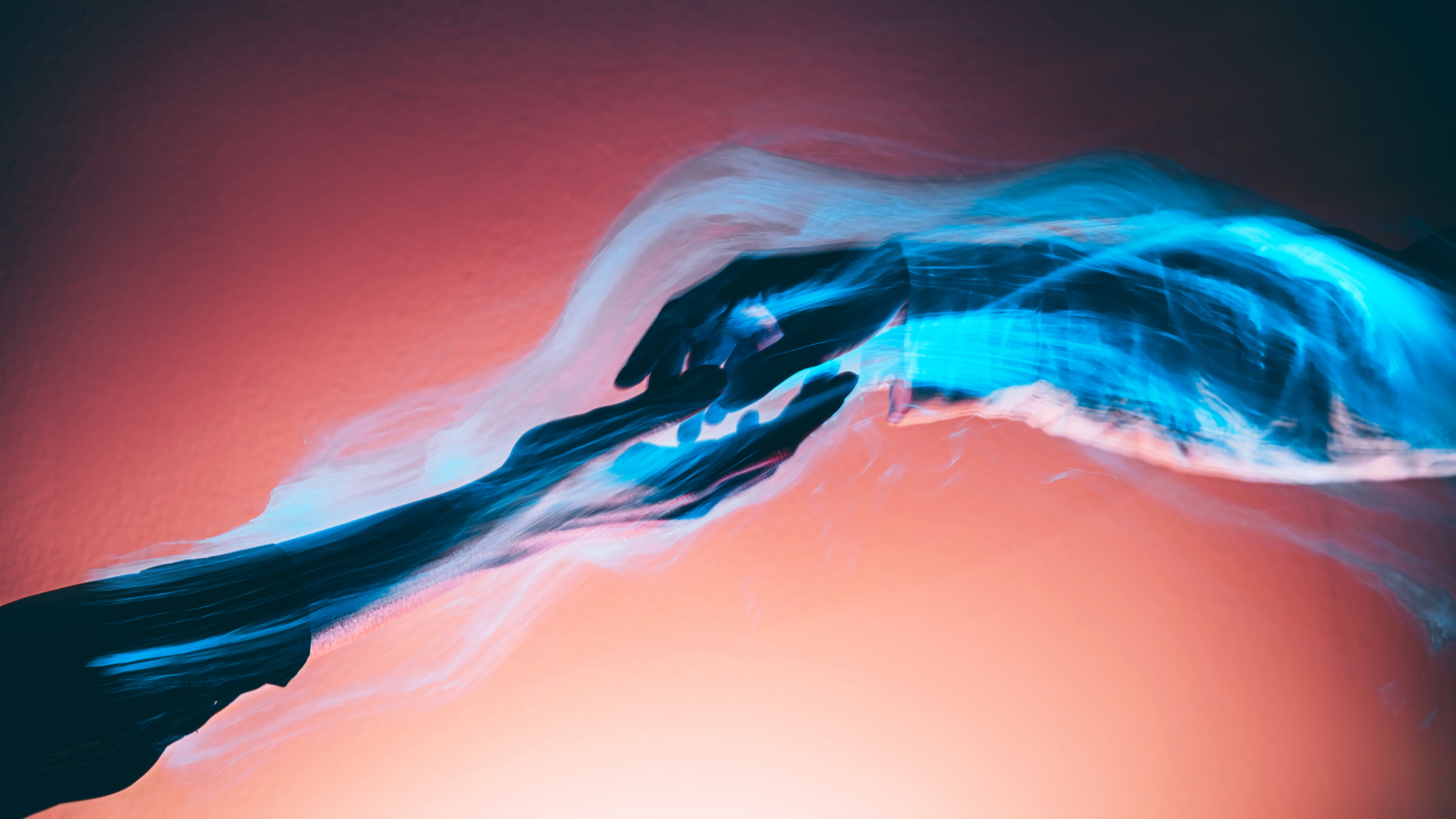 Two hands are touching against a vibrant crimson background, electrical energy light surrounding their connection.