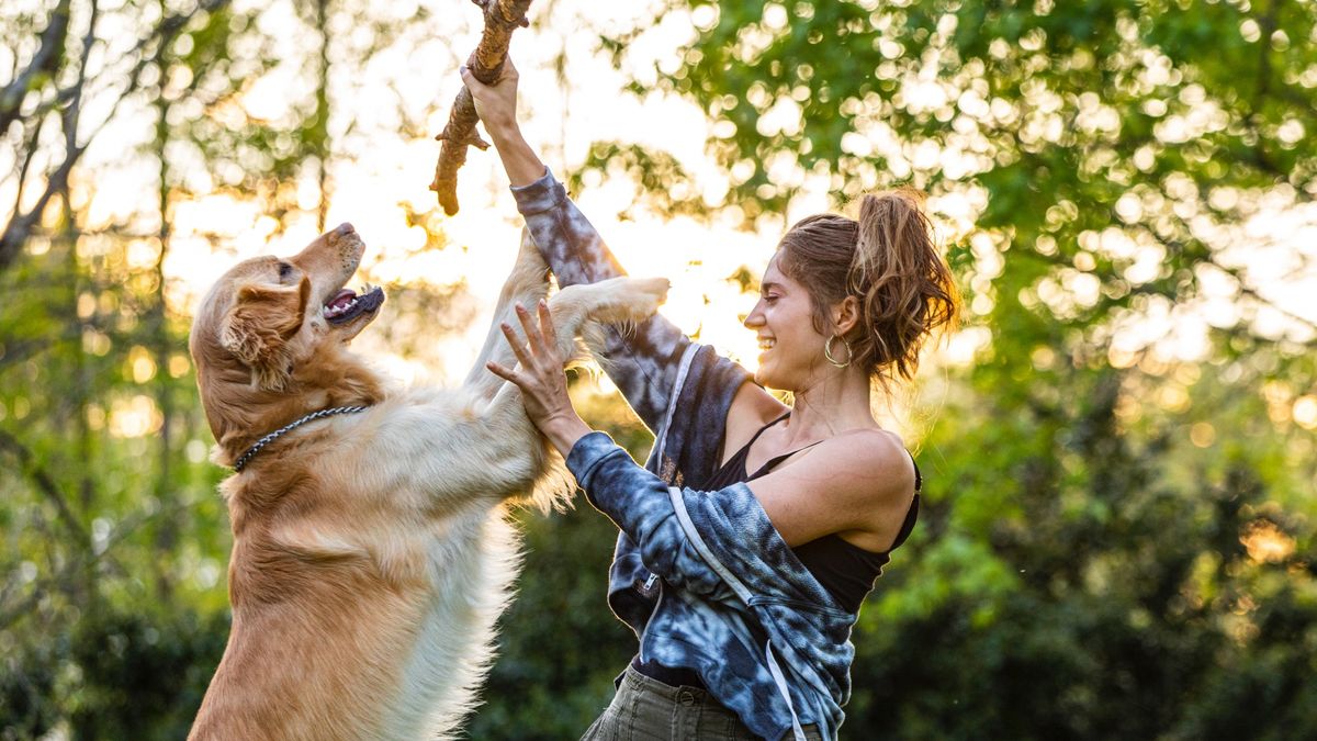 Woman playing with her dog outside