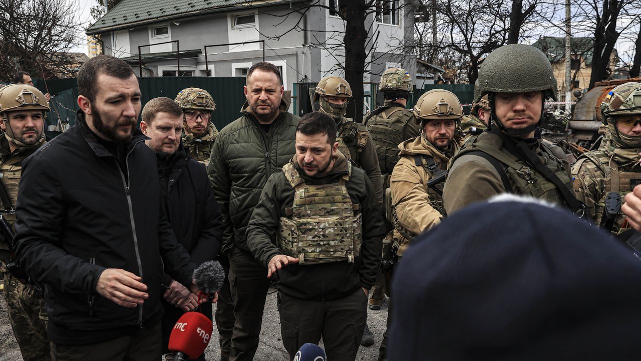 Volodymyr Zelenskyy speaks to reporters during a visit to Bucha