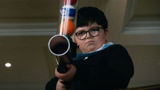 Archie Yates with pool balls in a gun in Home Sweet Home Alone