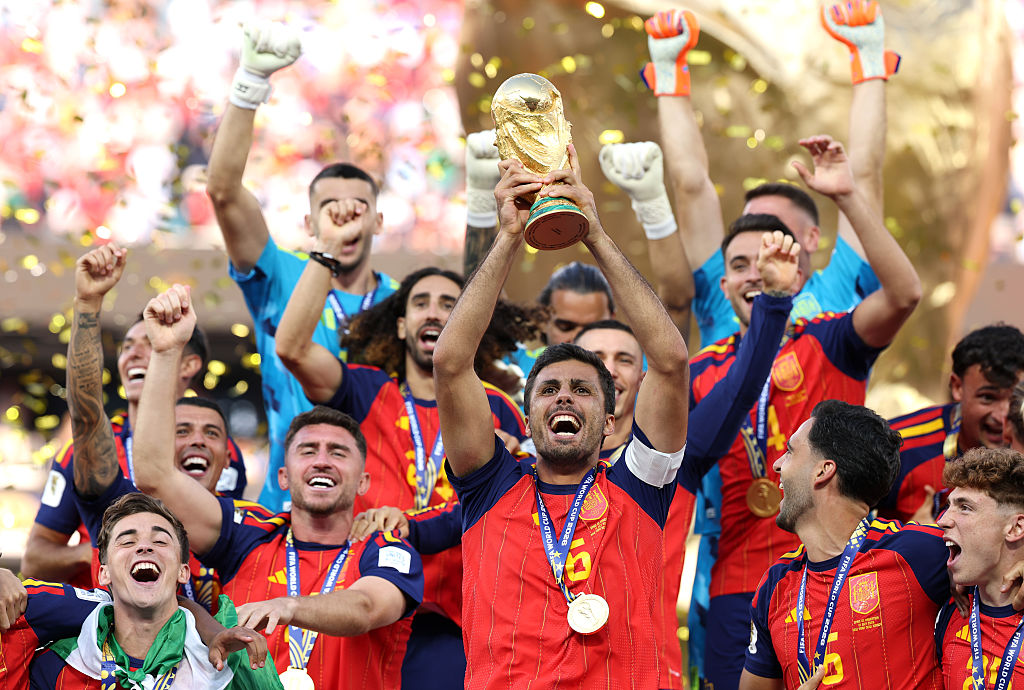 Rodri #16 of Spain lifts the FIFA World Cup Winner&rsquo;s Trophy. (Photo by Alex Pantling - FIFA/FIFA via Getty Images)