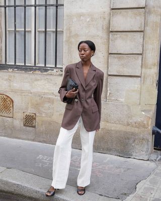 @sylviemus_ wearing brown blazer with white trousers