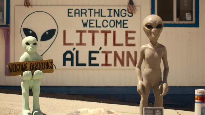 A bar that says &quot;Earthlings welcome, little aleinn&quot; with two alien figures stood outside