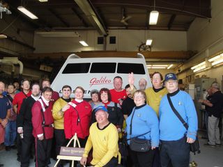 "Star Trek" fans, including members of the U.S.S. Justice and U.S.S. Challenger fan groups, pose with the fully restored Galileo shuttlecraft from the original "Star Trek" TV series during an unveiling on June 22, 2013, at Master Shipwrights Inc., in Atlantic Highlands, N.J.