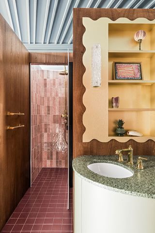 bathroom with pink tiles and green vanity