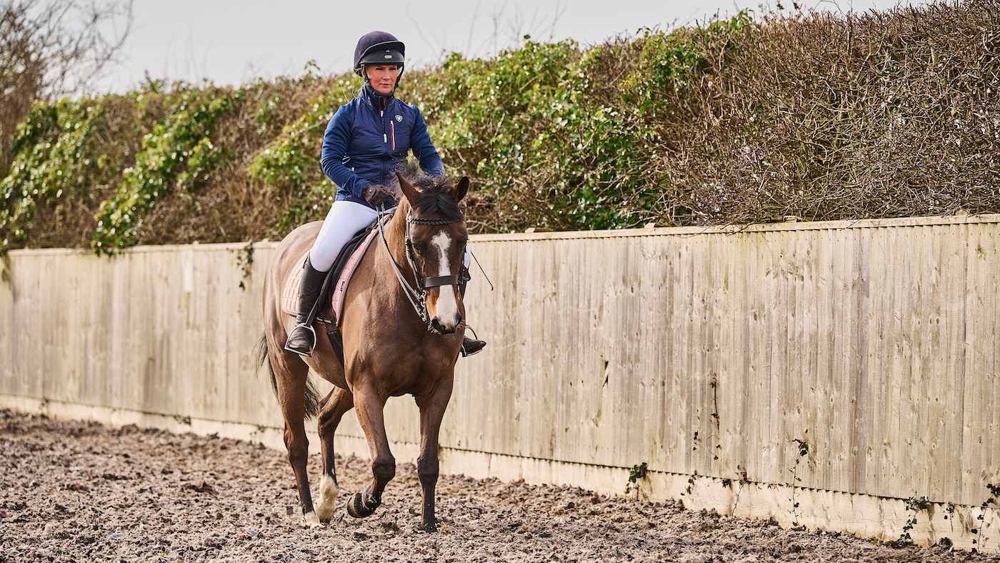 Riding in trot in an arena