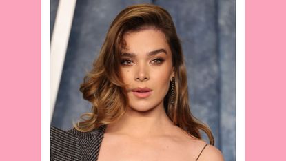 Hailee Steinfeld wears a black, sheer dress and a grey coat as she attends the 2023 Vanity Fair Oscar Party Hosted By Radhika Jones at Wallis Annenberg Center for the Performing Arts on March 12, 2023 in Beverly Hills, California/ in a pink template