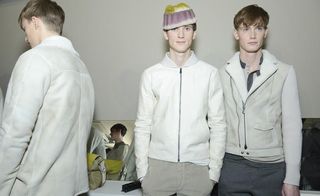 Three male models in white zip up jackets