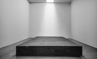 Large black platform in white room