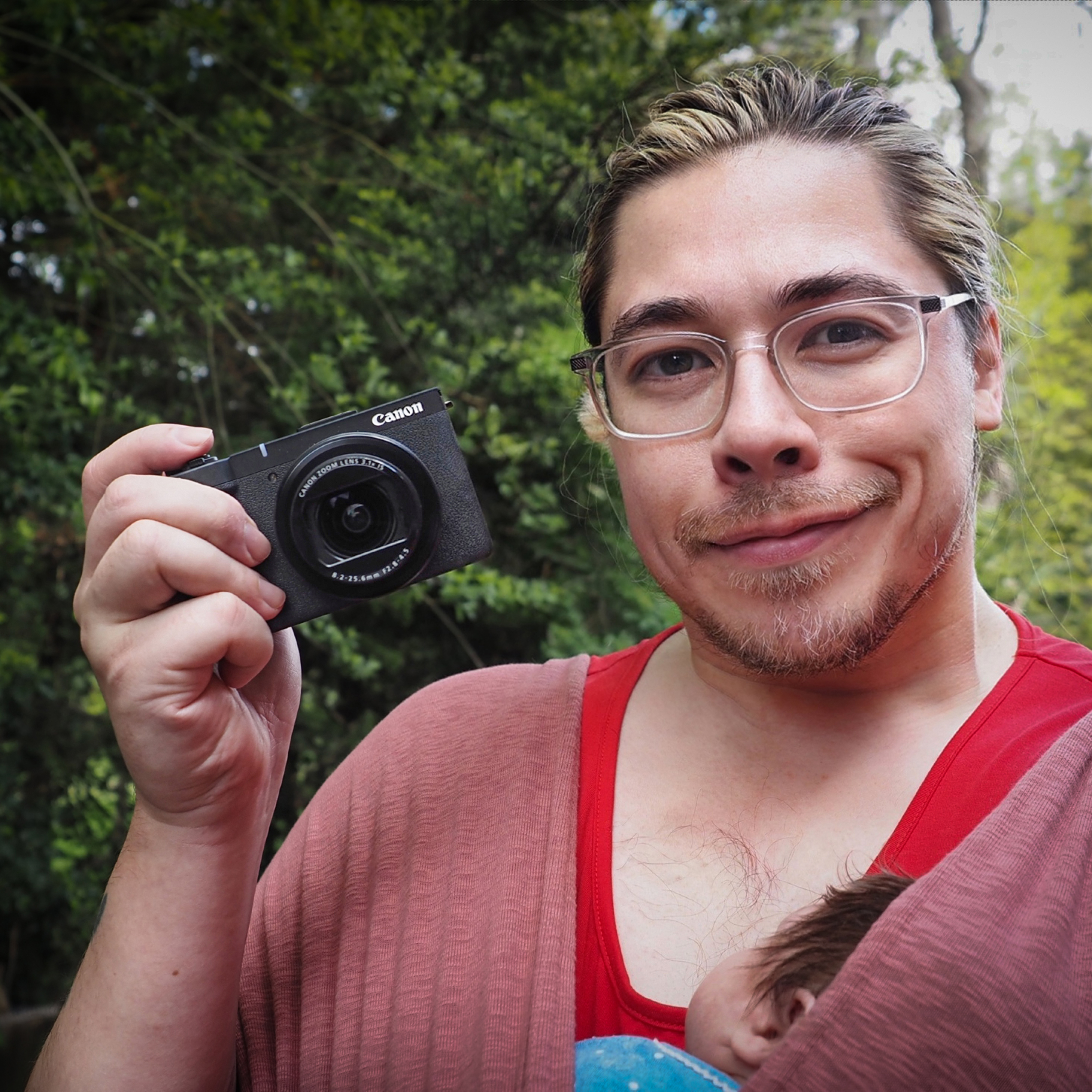 James Artaius holding a Canon PowerShot V1 compact camera outdoors