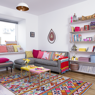 living room with wooden flooring and sofa with cushions