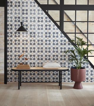 a hallway space with tile-inspired wallpaper and black aluminium glass feature