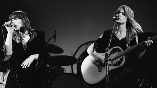 Ann (left) and Nancy Wilson of the rock group Heart perform onstage at the Universal Amphitheatre, Los Angeles, California, July 15, 1977