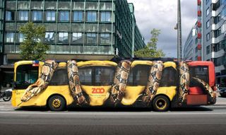 Trompe l'oeil: Bus wrap that looks like a snake crushing the vehicle