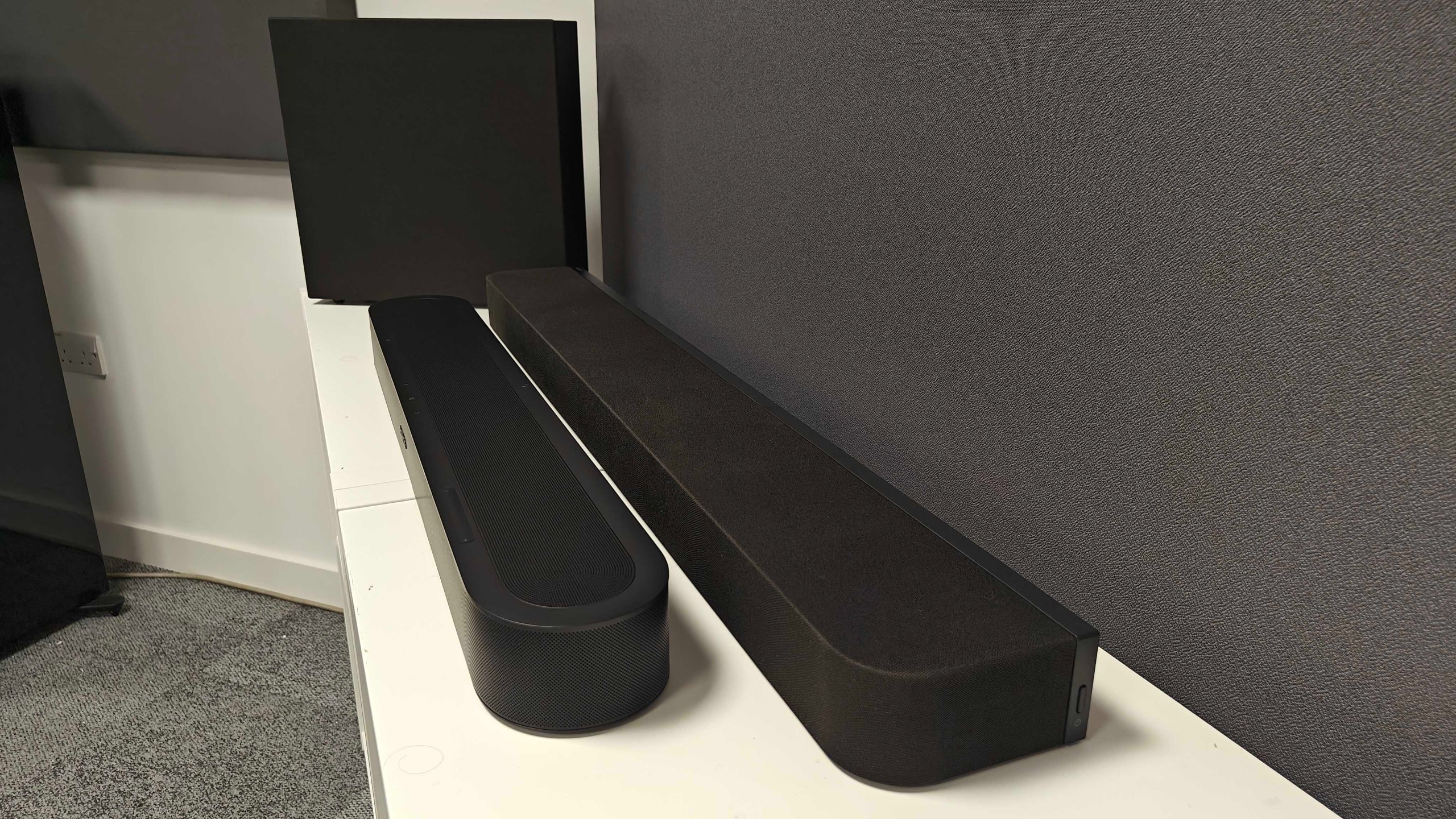 Sonos Beam Ultra and Sony Bravia Theatre Bar 7 + S on a white table