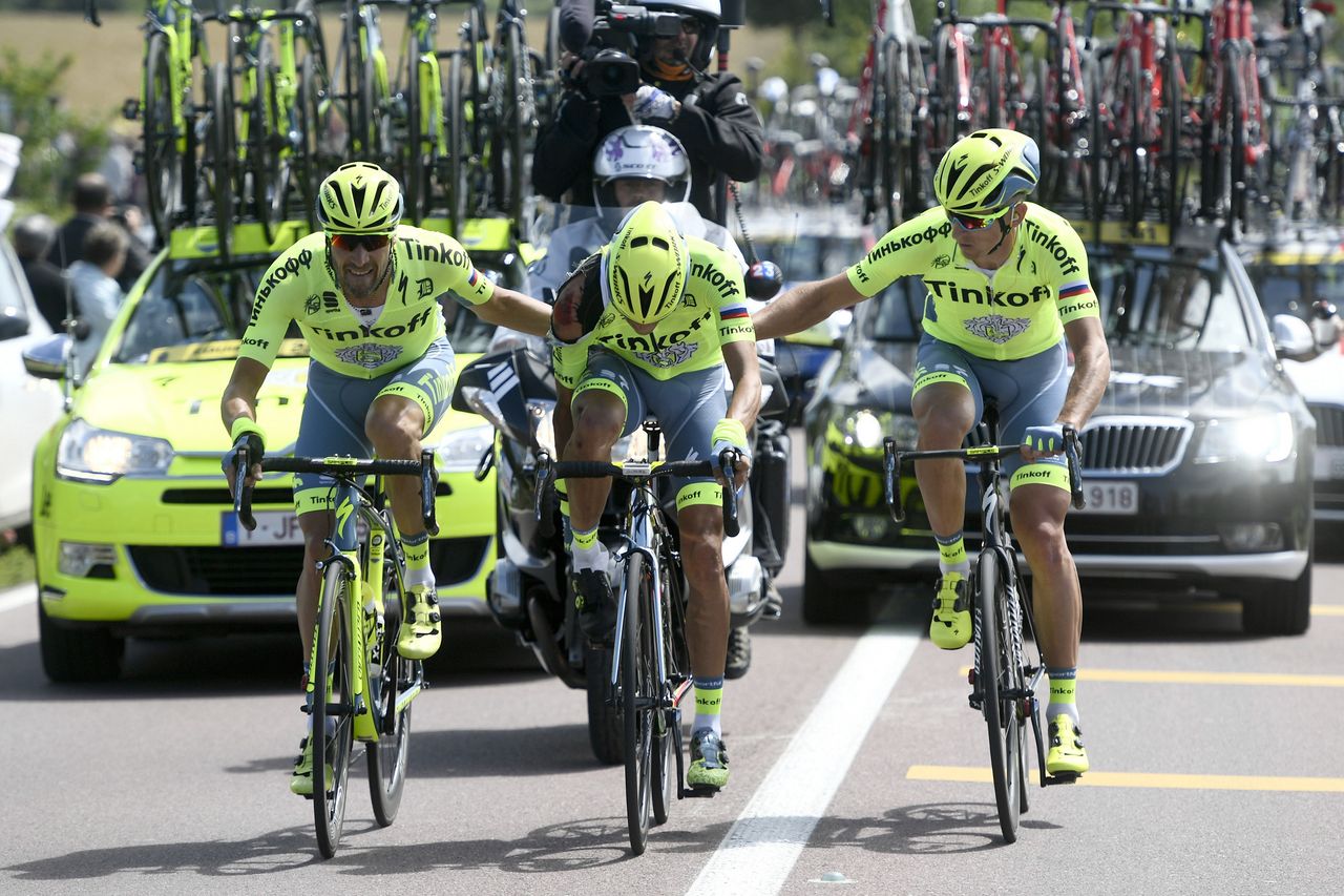 Alberto Contador is helped by Tinkoff teammates after his crash