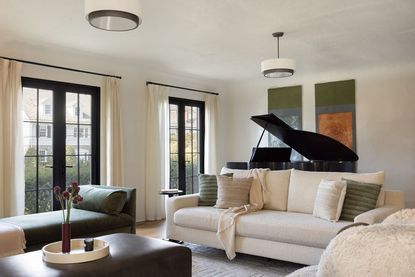 modern living room with white couch in front of grand piano