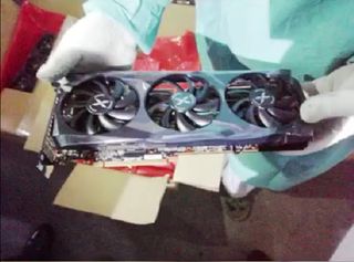 A still of a video showing a Chinese customs officer holding one of the seized XFX graphics cards