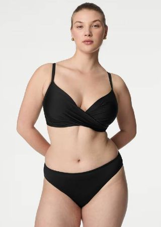 A model wearing a black bikini from M&S