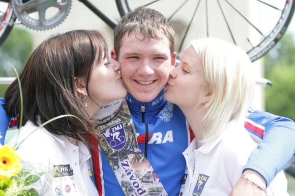 Evgeniy Shalunov gets the junior kisses for winning the Junior Peace Race.