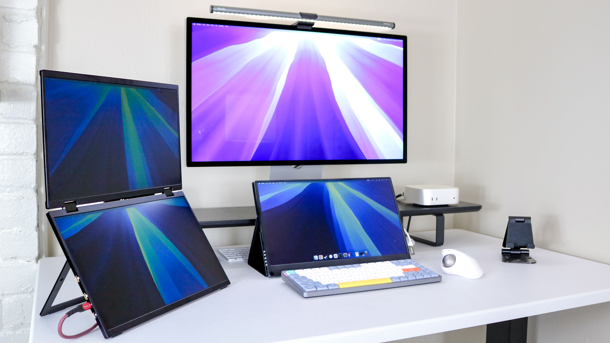 A triple monitor setup powered by the Mac mini M4