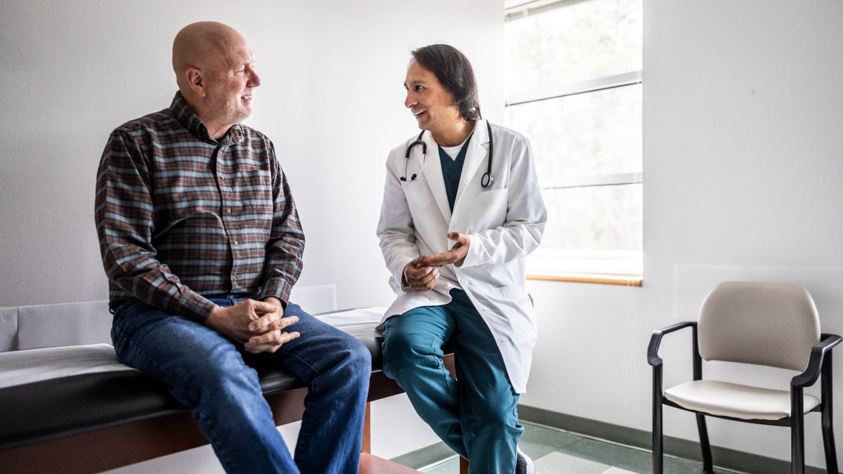 Doctor discussing treatment with senior man in exam room