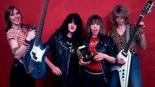 Portrait of British Heavy Metal group Girlschool as they pose in a studio, Chicago, Illinois, mid April, 1982. Pictured are, from left, Gil Weston, Kim McAuliffe, Denise Dufort, and Kelly Johnson