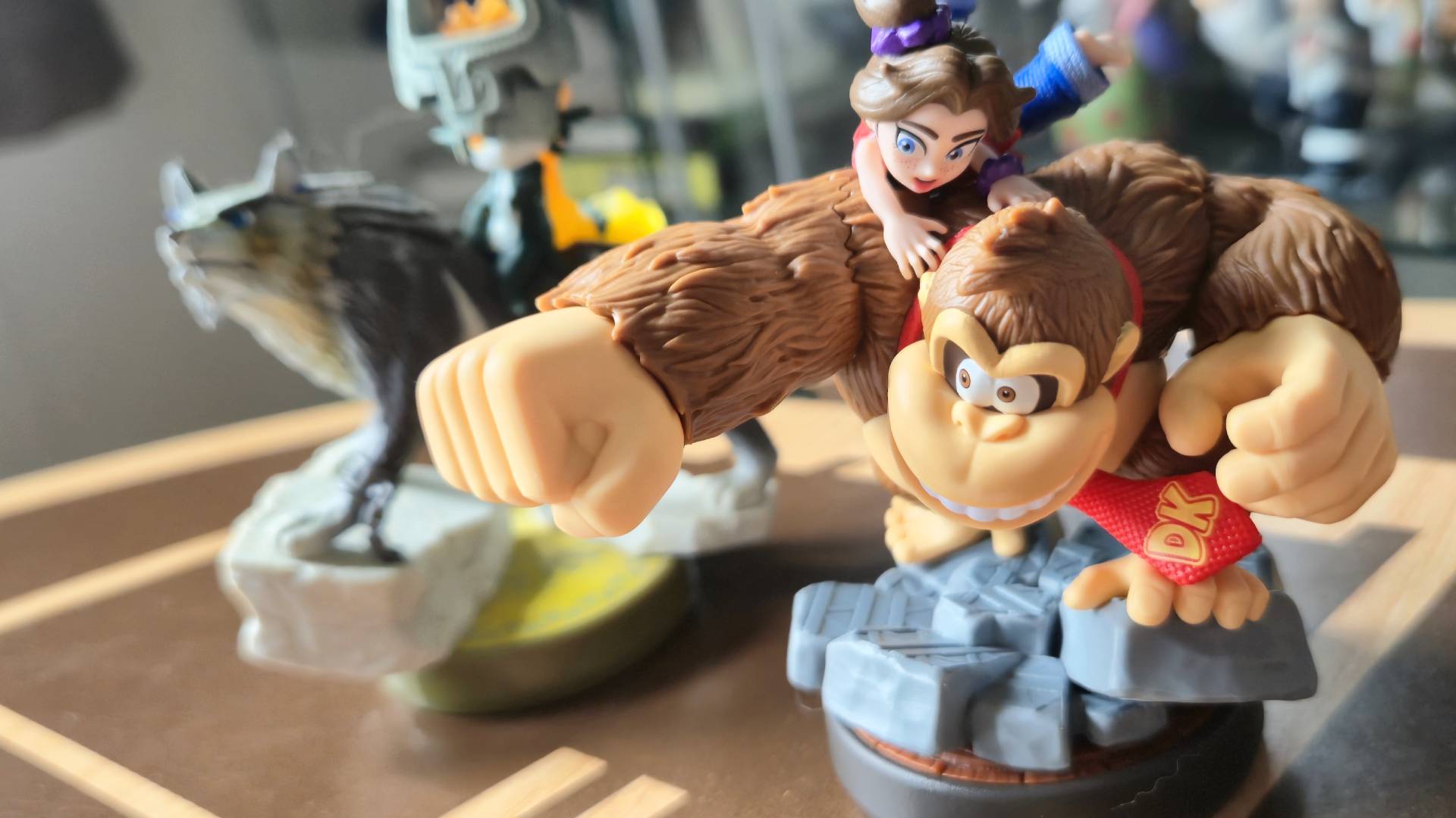 Photo by Rosalie Newcombe of the Donkey Kong Bananza amiibo standing in front of the Twilight Princess amiibo.