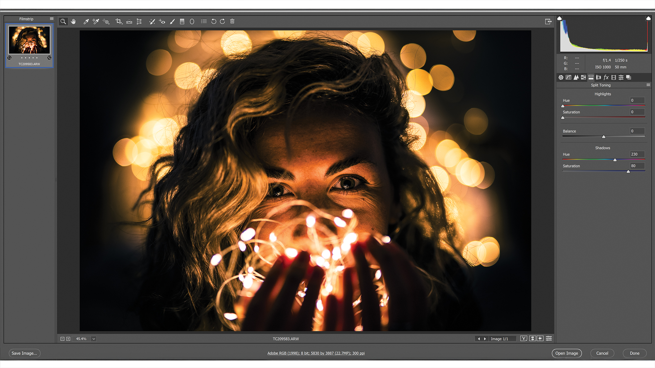 A Photoshop window with editing menus, an image in the center showing a person with wavy hair surrounded by soft, golden bokeh lights that create a warm and dreamy atmosphere