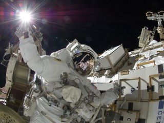 NASA astronaut Sunita Williams, Expedition 32 flight engineer, appears to touch the bright sun during the mission’s third spacewalk on Sept. 5, 2012. 