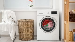 washing machine with rattan laundry bin and shelving in a laundry room