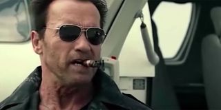 Arnold Schwarzenegger smoking a cigar.