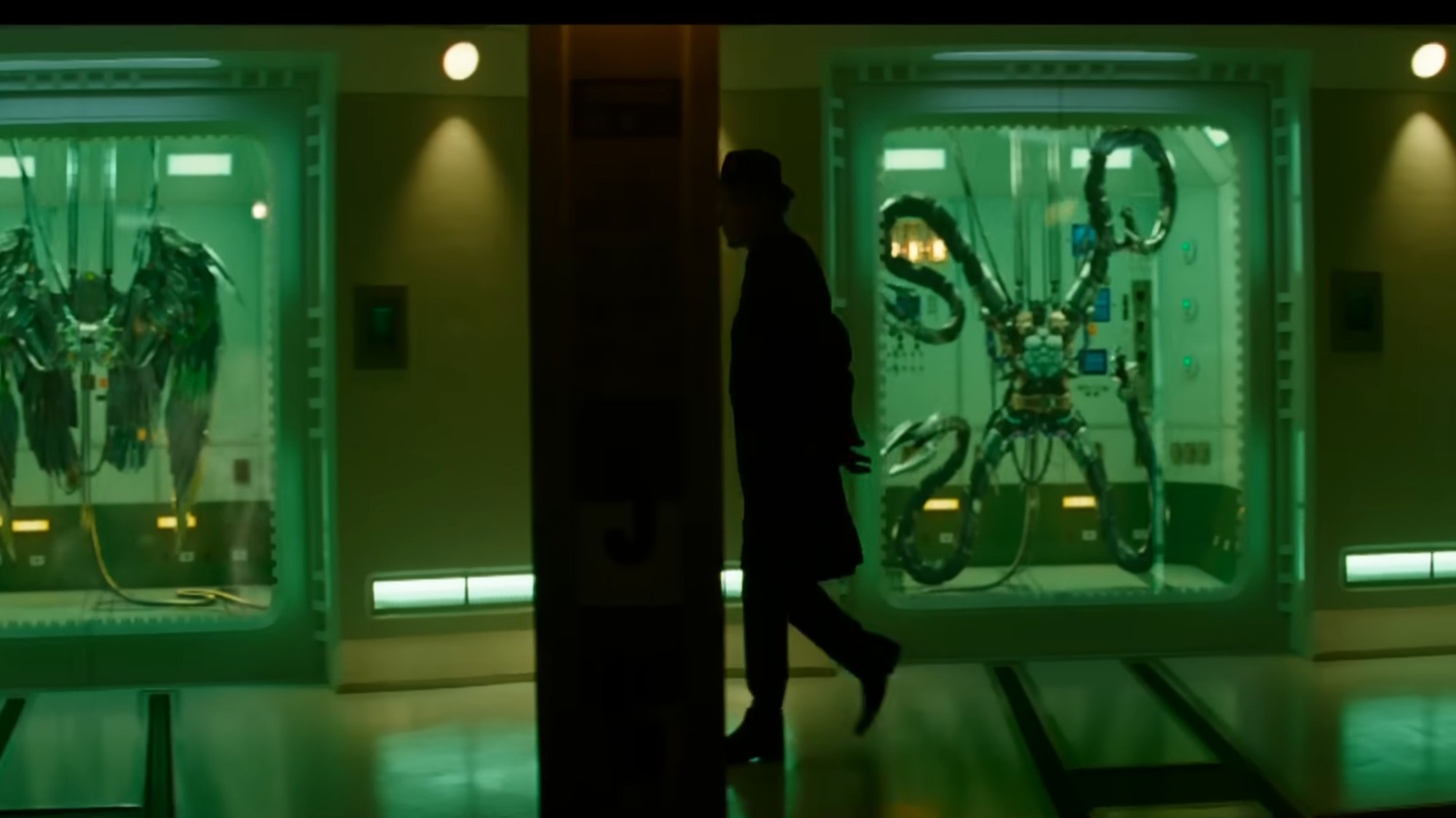 A man walking past famous villain contraptions in The Amazing Spider-Man 2