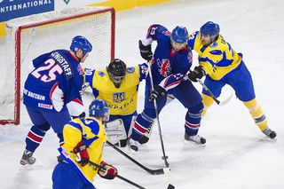 David Longstaff (L) and Owen Fussey (2nd R) of Great Britain vie for the puck with goalkeeper Mykhailo Balaban (2nd L) and Vitali Lyutkevych (R) during the 2012 IIHF Ice Hockey World Championship Div I Group A match between Ukraine and Great Britain at the Arena Stozice in Ljubljana, on April 18, 2012.