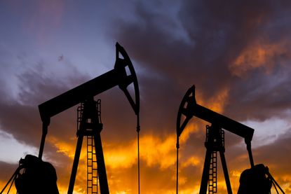 Oil pump on a sunset background. World Oil Industry