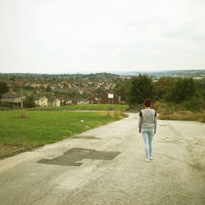 A woman walking down the road