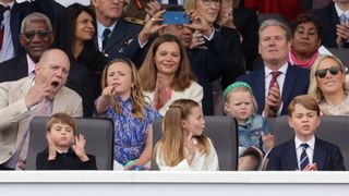 Mike Tindall, Mia Tindall, Victoria Starmer, Lena Tindall, Keir Starmer, Zara Tindall (front row) Prince Louis of Cambridge, Princess Charlotte of Cambridge and Prince George of Cambridge watch the Platinum Pageant on June 05, 2022 in London
