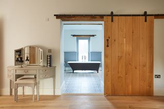 bathroom with bathtub and wooden door