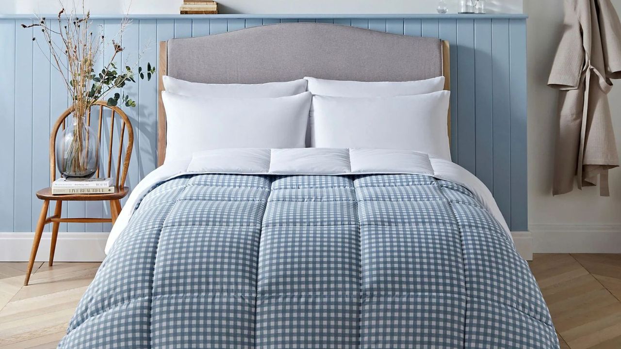 Night Lark Gingham Print Coverless Duvet against a blue wall. 