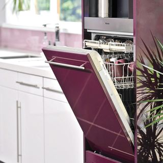 kitchen area with pink dishwasher and white drawers