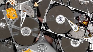 a photo of a pile of hard disk drives representing a guide on how to check your hard drive's health