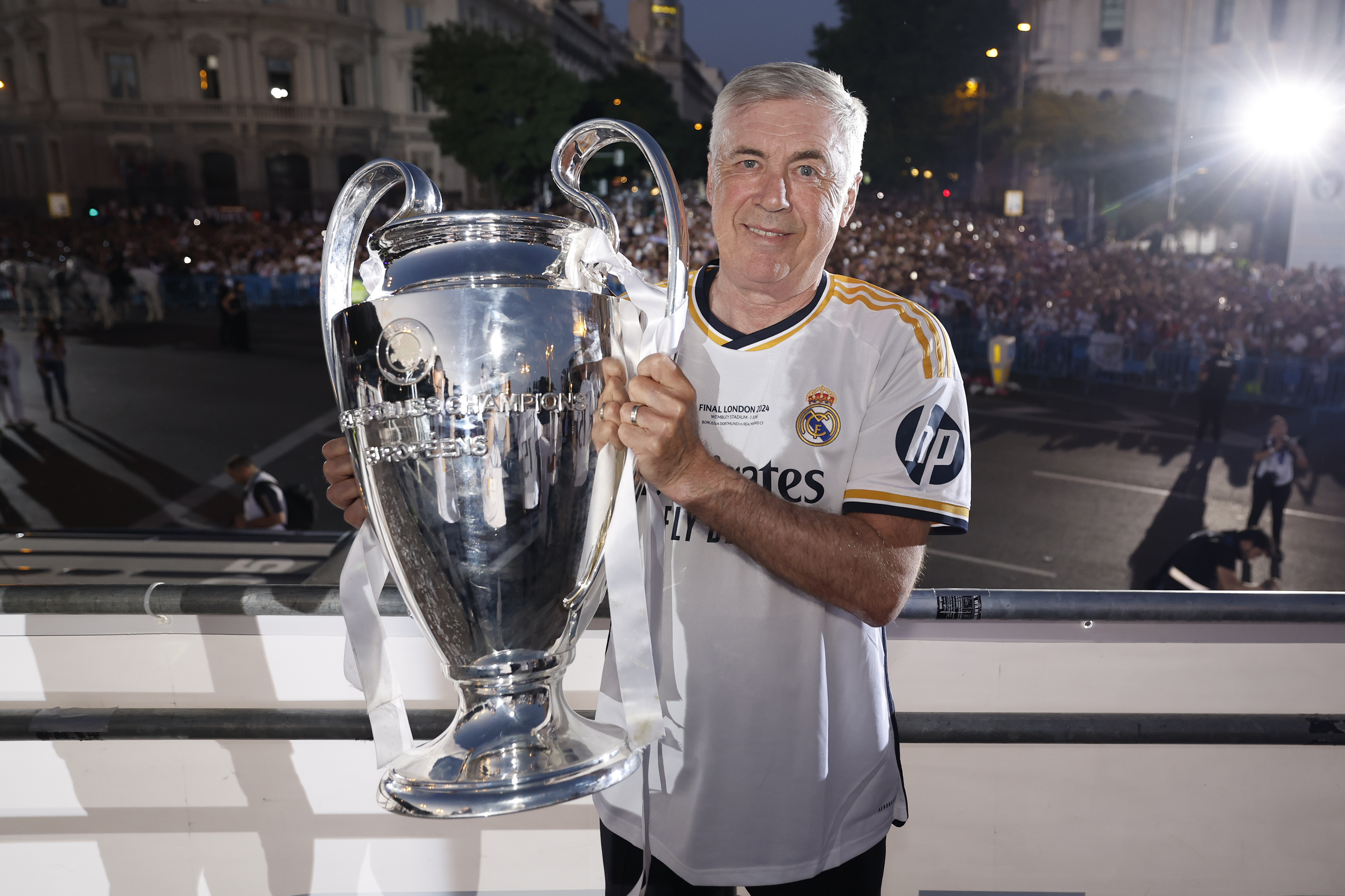 Carlo Ancelotti poses with the Champions League trophy during the celebrations following Real Madrid's win over Borussia Dortmund in the 2024 final.