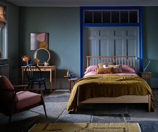 bedroom painted in blue with dark blue frame detail around panelling