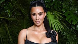 Kim Kardashian in a little black dress and satin hair ribbons, appeared at the Oscars 2025 Pre-Party