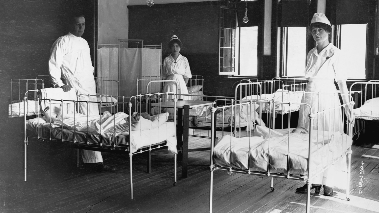 A doctor and two nurses tend to children suffering from paralysis due to the 1916 polio epidemic in Beacon, New York